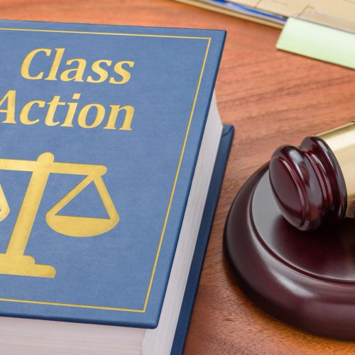 A law book with a gavel - Class action